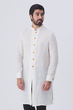 White linen kurta with front and cuff button placket
Components:1
Neckline:Mandarin
Sleeve Length:Full
Fabric:Linen
Color:White
Note: Pants worn by the model is not for sale - Aza Fashions Long Sleeve Off White Kurta For Summer, Casual White Linen Kurta, Off White Long Sleeve Summer Kurta, White Long Sleeve Bandhgala For Spring, Summer Long Sleeve Off White Kurta, White Stand Collar Kurta For Eid, White Fitted Kurta With Stand Collar, Fitted Linen Kurta For Spring, White Linen Fitted Kurta