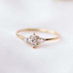 three stone diamond ring on white cloth