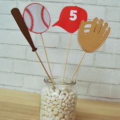 three baseball themed cupcake toppers in a mason jar filled with white chocolate chips