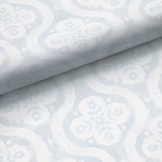 a blue and white wallpaper with an ornate design on it's surface,