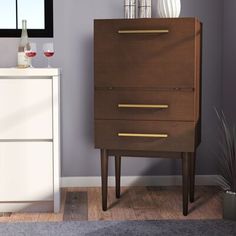 a tall wooden cabinet sitting next to a white dresser