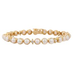 This Genuine 22.8 Carat Pearl and Diamond Tennis Bracelet in 18k Yellow Gold in 18K gold showcases endlessly sparkling natural pearl, weighing 22.8 carat and diamonds weighing 0.05 carats. It measures 7 inches long in length. Pearl symbolizes purity, determination and perfection. Designed with perfect round cut pearl set in gold with diamonds in between to make you stand out on any occasion or event. The elegant style complements the attire beautifully and is a perfect June Birthstone Bracelet.