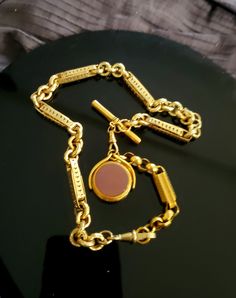 "This incredible Antique 9K gold fob chain stands out not only because of its beautiful design but also for its boldness and solid weight. The chain is made up of 2 sections which can be separated and worn as both a longer necklace with the pendant or just a shorter (15\") choker chain. The pendant drop is on a swivel and is reversible one side being a bloodstone and the other sardonyx. Please note that while the chain itself is 9K gold the drop swivel pendant is gold filled. As noted this chain Fob Chain Necklace, Memorial Ring, Choker Chain, Tiffany & Co., Long Necklace, Antique Gold, Chains Necklace, Beautiful Rings, Beautiful Design