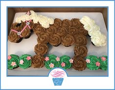 there is a cake shaped like a horse on the box with frosting and flowers