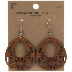 the earrings are made from wood and have laser cutouts on them, with an intricate design