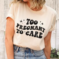 a woman wearing a t - shirt that says too pregnant to care