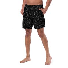 Dive into summer darkness with Goth Cloth Co.'s Gothic Halloween Swim Trunks. Featuring a haunting pattern of ghosts, pumpkins, black cats, and spider webs against a black and white backdrop, these trunks combine gothic elegance and Halloween flair, perfect for the darkly inclined beachgoer. Key Features: Four-way stretch fabric: Water-repellent microfiber made from 91% recycled polyester, 9% spandex. Anti-chafe liner: Silky 92% polyester, 8% spandex inner liner for all-day comfort. Multiple poc Fitted Black Witchy Bottoms, Black Bottoms For Summer Costume Party, Black Bottoms For Costume Parties In Summer, Black Rave Bottoms For Beach, Gothic Black Bottoms For Halloween, Black Rave Bottoms For Halloween, Rave Style Black Bottoms For Halloween, Black And White Backdrop, Darkly Inclined