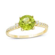 A colorful way to show your love, this gemstone and diamond engagement ring is the start of something beautiful. Crafted in warm 10K gold, this adventurous style features a 7.0mm spring-green peridot flanked by a pair of sparkling diamonds. Dainty diamonds line the shank for the perfect touch of shimmer. Radiant with 1/8 ct. t.w. of diamonds and a brilliant buffed luster, this engagement ring is a unique choice to celebrate your romance. Peridot Engagement Rings, Peridot Jewelry, Engagement Ideas, Peridot Stone, Natural Diamond Engagement Ring, Green Peridot, August Birth Stone, Spring Green, Sparkle Diamonds