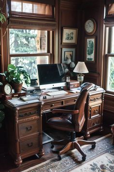 a desk with a computer on top of it next to a window and potted plants