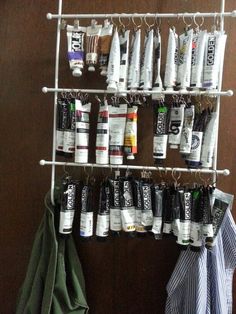 a coat rack filled with lots of different types of toothpaste