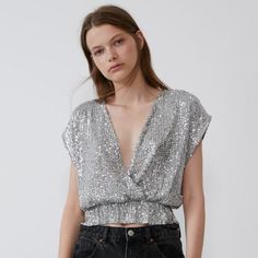 Nwt Zara Size S Gray Sequin Top Brand New With Tags Sleeveless Wrap-Front Top With Deep V-Neck. Elastic Waist. - 96% Polyester, 4% Elastane - Approximate Measurements: 20el" Armpit To Armpit, 19.5" Length V-neck Shimmer Tops For Party Season, Chic Shiny Tops For Party Season, Chic Metallic Tops With Shine Detail, Chic Metallic Shine Tops, Shiny Summer Tops For Night Out, Shiny Sleeveless Tops For Summer, Metallic Shiny Tops For Summer, Sleeveless Shiny Tops For Summer, Metallic Shiny Summer Tops