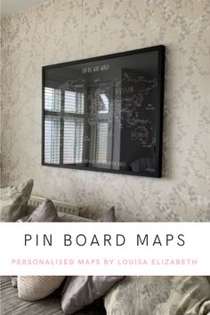 a bed with pillows and a blackboard on the wall above it that says pin board maps