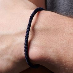 a man's arm with a bracelet on it