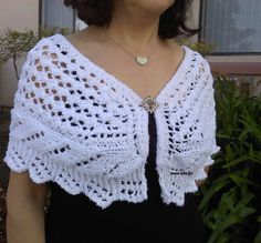 a woman wearing a white crocheted shawl