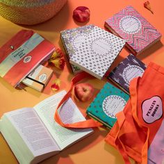 an open book sitting on top of a table next to some fruit and other items