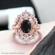 a black and white diamond ring sitting on top of a table