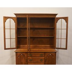 an old fashioned wooden china cabinet with two doors and three drawers on one side,