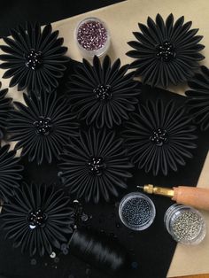 black paper flowers and glitters on a table