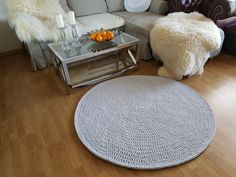 a living room filled with furniture and a white rug