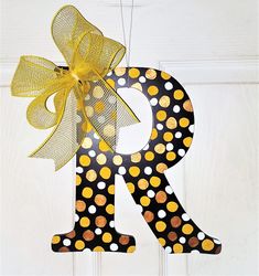 the letter r is decorated with polka dots and a bow on it's front door