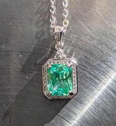 "stones were examined by a certified gemologist. Elevate Your Style with Our 9x7mm Sea Foam Green Spinel Pendant and Halo Experience the allure of natural beauty with our captivating 9x7mm Sea Foam Green Spinel Pendant, elegantly accented by a mesmerizing halo design. This pendant is a true embodiment of timeless elegance and sophistication. 🌟 Key Features: 💎🌊Genuine Sea Foam Green Spinel: Adorned with a genuine 9x7mm Sea Foam Green Spinel, prized for its unique and enchanting color reminiscent of ocean waves. 💎🌊Mesmerizing Halo Design: The exquisite halo setting enhances the Spinel's radiance, framing it with a circle of sparkling brilliance that draws attention from every angle. 💎🌊Versatile Elegance: Perfect for both formal occasions and everyday wear, this pendant effortlessly co Gia Certified Elegant Emerald Gemstones, Elegant Gia Certified Emerald Gemstones, Classic Emerald Cut Gemstones With Halo Setting, Elegant Green Gia Certified Gemstones, Elegant Emerald Gemstones With Accent Stones, Elegant Emerald Cut Gemstones With Accent Stones, Elegant Emerald Gemstones With Halo Setting, Gia Certified Emerald Cut Gemstone For Fine Jewelry, Gia Certified Emerald Cut Fine Jewelry Gemstones