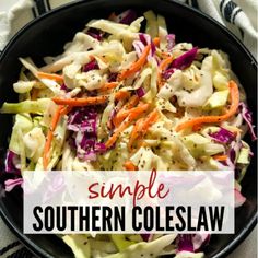 a bowl filled with coleslaw and carrots on top of a white table cloth