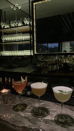 three martinis are lined up on the bar