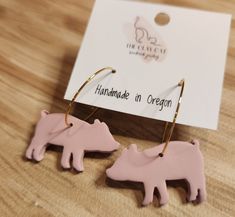 "Celestial Farms is pleased to partner with The Clay Cat and bring you some amazing \"Farm Swag.\" These are pink piglets made from polymer clay - on yellow gold colored stainless steel hoops. These handcrafted earrings are made from clay polymer. all of the ear hooks are silver or gold plated, hypoallergenic and nickel free.  Item is as shown, not made to order. The item that is pictured is the item that you will receive.  Earring care - if cleaning is necessary, use a damp, soft cloth or cotto Pig Clay Ring, Cowboy Polymer Clay Earrings, Clay Pig Earrings, Beeswax Moisturizer, Flying Pig Earrings, Bees Wax Lip Balm, Pig Earrings, Pig Jewelry, Horse Earrings