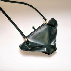 Made from genuine natural Toscan leather without chrome. A unique shape inspired by the animal world and organic lines. It can be held in the hand for a more elegant style or used with a detachable leather strap.The bag has one small inner pocket and one outer pocket with a classic metal lock. Not only a bag, but also a sculpture to be wornThe dimensions of the envelope are 17x 15 x 10 cmFor carrying in the hand or over the shoulder thanks to a removable leather strip with a length of 120 cm.Han Animal World, Organic Lines, Classic Metal, A Bag, Elegant Style, Leather Straps, Genuine Leather, Envelope, Sculpture