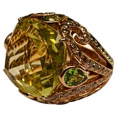 This statement Cocktail Ring centering a large cushion shaped vivid yellowish green lemon citrine. Surrounded by Champagne colored glittering diamonds and Tsavorite garnets, all fancifully set in 18 K Rosegold. The ring is currently size 54/14 but can be resized larger or smaller if necessary. Luxury Multi-stone Yellow Gemstones, Luxury Yellow Multi-stone Gemstones, Luxury Yellow Multi-stone Jewelry, Luxury Yellow Gemstones With Accent Stones, Luxury Tsavorite Jewelry With Gemstone Accents, Luxury Yellow Diamond Gemstones, Luxury Green Rings With Gemstone Accents, Exquisite Green Jewelry With Pave Setting, Luxury Tsavorite Ring With Gemstone Accents