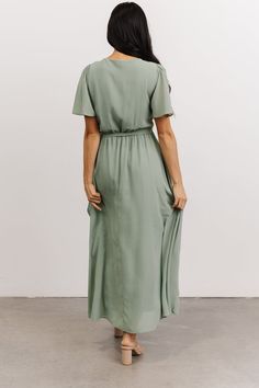 Our Waverly Wrap Dress is waiting for you! With a true wrap silhouette, high-low tulip skirt, and gorgeous movement, you'll feel beautiful! Green Dress Modest, Carol Dress, Sage Green Bridesmaid Dress, Sage Green Dress, Dusty Sage, Dress Modest, Baltic Born, Tulip Skirt, Green Bridesmaid Dresses