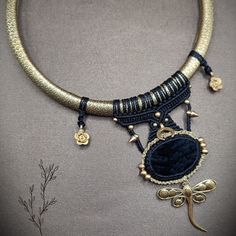 "❤️Macrame necklace on brass choker with Black Obsidian  cabochon , brass Dragonfly charm and other brass beads and charms.  ❤️I made this boho black & gold macrame necklace using the macrame technic with waxed thread strings, and  added brass beads to it. This  macrame piece is made with \"Linhasita\" string (polyester waxed string). It is strong, doesn't lose its colors with water. ❤️The interweaved strings are hooked on a brass base. Brass is nickel-free and hypoallergenic. To put it on, the Macrame Choker Necklace, Brass Choker, Macrame Choker, Necklace Macrame, Macrame Boho, Dragonfly Charm, Brass Beads, Dream Doll, Macrame Necklace