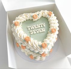 a heart shaped cake with the words twenty seven written on it in white frosting