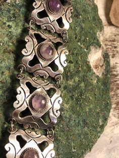 1940s Mexcian Sterling Silver Scroll Amethyst Cab Vintage Bracelet Bracelet Measures 7 inches 1 1/2 Solid in weight Vintage Sterling Silver Bracelet With Gemstone, Vintage Adjustable Purple Jewelry, Adjustable Vintage Purple Jewelry, Vintage Silver Gemstone Bracelets, Vintage Silver Amethyst Bracelets, Vintage Silver Bracelets With Gemstones, Vintage Amethyst Bracelet Jewelry, Handmade Vintage Amethyst Jewelry, Vintage Amethyst Purple Jewelry