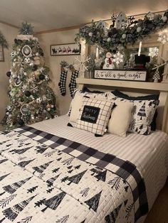 a bedroom decorated for christmas with black and white decorations on the wall, trees in the background