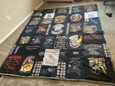 a black blanket covered in patches and t - shirts