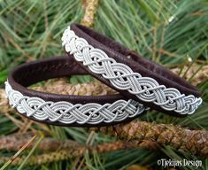 "Spun pewter silver braid, hand stitched on soft reindeer leather or lambskin, and completed with a naturally shed hand carved reindeer antler button. Width: approx. 1 - 1,2 cm (0,4\"-0,47\"). Ships in a nice handmade gift box. Design: MIDGARD - The human world; Earth and one of the Nine Worlds in Norse mythology. LEATHER COLORS AND STYLES: Please see last photo - 30 colors to choose from. SIZE: Please measure your wrist and add 1 cm (0,4\"), for a perfect snug fit. The soft leather will stretch Handmade Viking Leather Bracelet, Adjustable Viking Style Leather Bracelet, Antler Buttons, Viking Bracelet, Reindeer Antlers, Leather Wristbands, Silver Work, Gorgeous Bracelet, Leather Cuffs