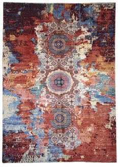 an orange, blue and red rug with abstract designs on the bottom half of it