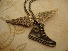 a necklace with a shoe and wings on it