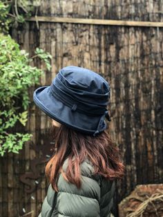 The 'April' Hat is the perfect hat for wet weather. Being both practical and stylish this rain hat will keep you dry even on the most rainy of days. Whether you are out on a dog walk or wandering through town, this hat can be pulled out of your bag and will always look great and keep you dry. It is made from high quality British antique finished waxed cotton. Constructed with a boned brim this is a hat that is forgiving when put in your bag and will always pop back to shape, ready to be worn.   Reminiscent of classic country style, the April hat is a simple yet elegant autumn/winter essential.  Lined with a combination of waterproof fleece and brushed cotton to provide warm and comfort, the hat is finished with a tie which can be used to secure the hat even further if needed for those wind Waterproof Hat, Pop Back, Dog Walk, Rain Hat, Velvet Hat, Fall Hats, Summer Sun Hat, Rain Gear, Cotton Hat