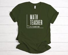 a green t - shirt with the words math teacher on it