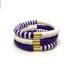 Lightweight, purple and white stack soft African disc bracelets are a perfect way to add a little sparkle to an outfit:). It is an easy on stretch bracelet that can be worn by itself or stacked. The bracelet is made of polymer clay with a brass barrel bead. The listing is for the stack:) White Stacked Beaded Bracelets For The Beach, White Stretch Bracelet With Stacked Round Beads, White Stacked Stretch Bracelet With Round Beads, Adjustable Stacked White Beaded Bracelets, Adjustable White Stacked Beaded Bracelets, White Stacked Stretch Bracelet As Gift, White Stacked Stretch Bracelet Gift, Adjustable White Stacked Stretch Bracelet, White Adjustable Stacked Stretch Bracelet