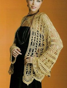 a woman wearing a crocheted shawl and black dress