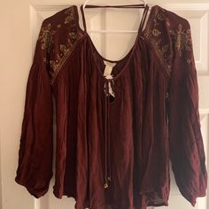 Wine Bohemian/Off The Shoulder Blouse. Bronze Embellished Shoulders. Fall Bohemian Blouse With Boho Collar, Rayon Tops For Fall Festival, Rayon Blouse For Fall Festival, Hippie Floral Embroidered Tops For Fall, Bohemian Fall Festival Blouse, Festival Long Sleeve Rayon Tops, Fall Embroidered Rayon Blouse, Fall Festival Bohemian Peasant Top, Festival Boho Print Rayon Blouse