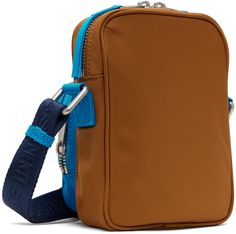 Nylon canvas messenger bag in tan and blue. · Adjustable and detachable logo-woven crossbody strap · Zip compartment and logo patch at face · Two-way zip closure · Patch pocket at interior · Satin lining · H6.75 x W5 x D1.75 Supplier color: Tobacco Blue Travel Bag With Logo Patch, Travel Crossbody Shoulder Bag With Logo Patch, Crossbody Travel Bag With Logo Patch, Leather Shoulder Bag With Logo Patch For Everyday Use, Leather Shoulder Bag With Logo Patch, Everyday Crossbody Bag With Logo Patch, Modern Shoulder Bag With Logo Patch For Everyday, Canvas Messenger Bag, Nylon Bag