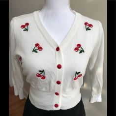 Super Soft Sweater Features Embroidered Red Cherries And Red Satin Covered Buttons. Looks So Good With A Black Pencil Skirt! Length Is Approximately 16 And Bust 17.5. Purchased From Local Boutique. Nwt White Embroidered Winter Tops, Winter White Embroidered Tops, Fitted Floral Embroidery Tops For Winter, Cherry Sweater, Cream Knit Cardigan, Woven Cardigan, Crochet Cardigan Sweater, Polka Dot Sweater, Colored Cardigans