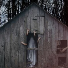 two hands coming out of a barn door with the ghost in it's arms