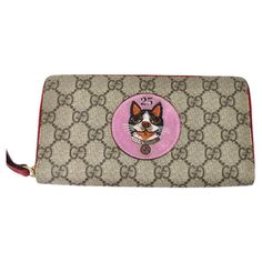 Calling all cat lovers, your new favorite wallet has arrived! Super fun brand new Gucci monogram wallet featuring an embroidered cat motif at the center circa 2017. Signature Gucci monogram is offset by a bright pink circle with a cat and lucky number 25 embroidery. Complete with gold hardware and a gorgeous cherry red leather lining featuring twelve card slots, three bill slots, and one zip closure coin pouch. Match this to your Gucci monogrammed Jackie handbag and complete the look with some g Cat Motif, Zip Purse, Gucci Monogram, Gucci Wallet, Wallet Pouch, Zip Wallet, Coin Pouch, Gucci Handbags, Small Accessories