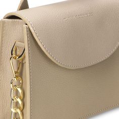 Enhance your accessory collection with this elegant beige handbag, adorned with sleek silver hardware. Made from premium leather, it features a practical interior space for essentials and includes a hand holder and a chain. Ideal for the modern woman, this handbag reflects strength and sophistication. Timeless Evening Bag For Everyday Use, Beige Rectangular Shoulder Bag With Chain Strap, Elegant Taupe Shoulder Bag With Palladium Hardware, Elegant Taupe Shoulder Bag With Metal Hardware, Beige Top Handle Shoulder Bag For Everyday Luxury, Beige Shoulder Bag With Chain Strap, Everyday Cream Bag With Chain Strap, Modern Beige Crossbody Box Bag, Taupe Shoulder Bag With Palladium Hardware For Everyday