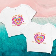 two t - shirts with the words hot new and hot pink on them in front of an ocean background